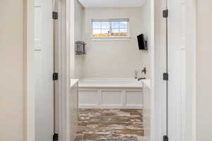 Bathroom featuring hardwood / wood-style flooring and a bath