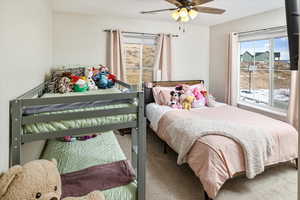 Carpeted bedroom with ceiling fan