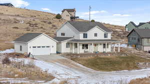 View of front of property with a porch and a garage