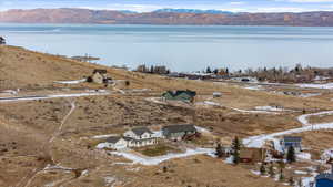 Snowy aerial view with a water and mountain view