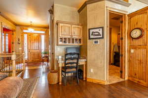 Interior space with crown molding and dark hardwood / wood-style floors