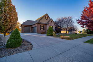 View of front of home with a garage and a front lawn