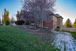 View of side of property featuring a lawn