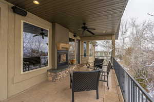 View of patio featuring ceiling fan and a balcony