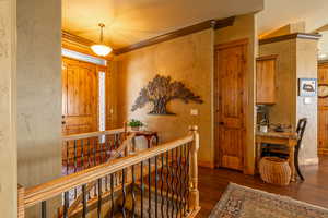 Hall featuring dark hardwood / wood-style floors and ornamental molding