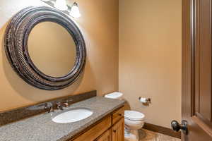 Bathroom with tile patterned flooring, vanity, and toilet