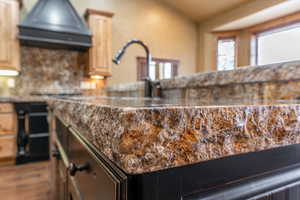 Room details with light brown cabinets and exhaust hood