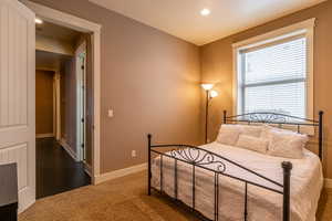 Bedroom featuring dark colored carpet