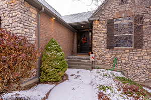 View of snow covered property entrance