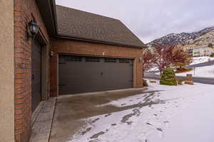 Snow covered garage with a mountain view