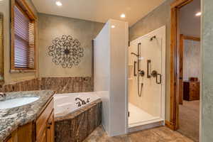 Bathroom with vanity and independent shower and bath