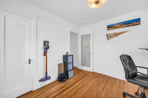 Office area with hardwood / wood-style floors