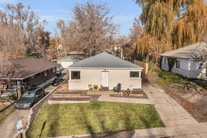 Rear view of house with a yard and a patio area