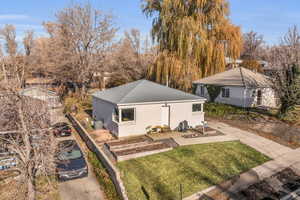 Back of house featuring a yard, a patio, and central AC unit