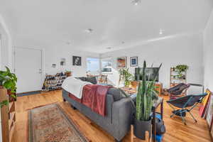 Bedroom with light hardwood / wood-style floors