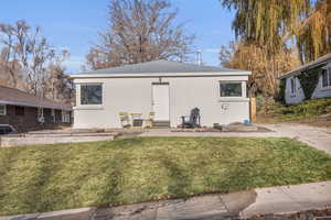 Rear view of property featuring a lawn