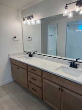 Bathroom with tile patterned floors and vanity