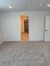 Carpeted empty room with a textured ceiling