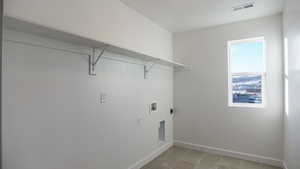 Laundry room featuring washer hookup, a wealth of natural light, and hookup for an electric dryer