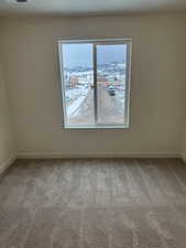 Empty room with carpet and a mountain view