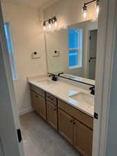 Bathroom with tile patterned flooring and vanity