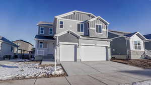 View of front of house featuring cooling unit and a garage