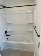 Bathroom featuring tile patterned flooring and shower / bathing tub combination