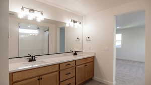 Bathroom featuring walk in shower, vanity, and a textured ceiling