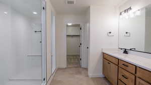 Bathroom featuring walk in shower and vanity