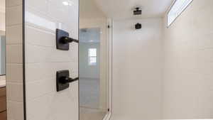 Bathroom featuring vanity and a tile shower