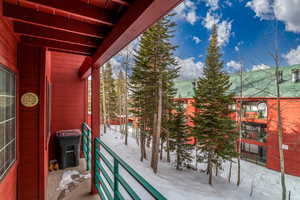 View of snow covered back of property