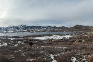 Property view of mountains featuring a water view