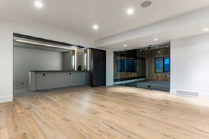 Linving room area for a pool table and enty to the gy and theater.