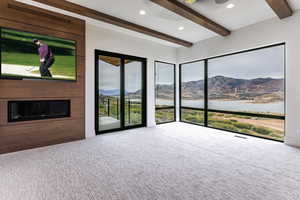 Primary Bedroom with a fireplace, a deck, a stone walls and Jordanelle and Deer Valley Views.