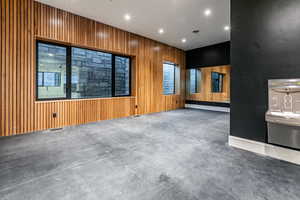 Home Gym with decrative wood trim, mirrors, rubber floors, european glass door and a drinking fountain.