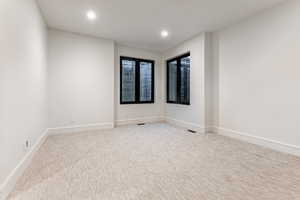 Bedroom 3  with recessed lighting and light carpet