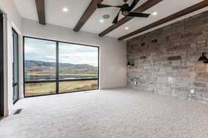Primary Bedroom with a fireplace, a deck, a stone walls and Jordanelle and Deer Valley Views.