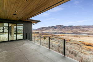 View of patio / terrace with a water and mountain view