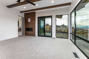 Primary Bedroom with a fireplace, a deck, a stone walls and Jordanelle and Deer Valley Views.