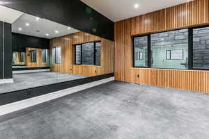 Home Gym with decrative wood trim, mirrors, rubber floors, european glass door and a drinking fountain.