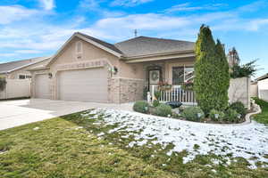 Single story home featuring covered porch and a garage