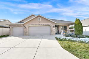 Ranch-style home with covered porch and a garage