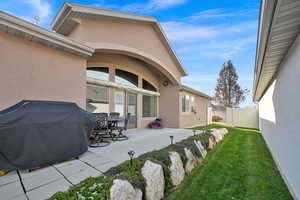 Exterior space featuring a patio area and a lawn