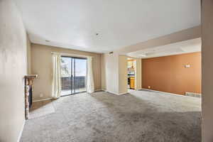 Unfurnished living room with light carpet