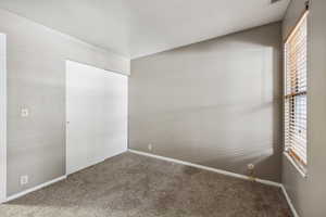 Unfurnished room featuring carpet flooring