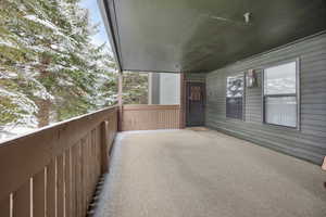 View of snow covered back of property