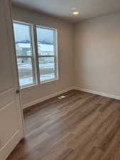 Empty room with hardwood / wood-style floors