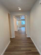 Hallway with dark hardwood / wood-style flooring