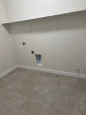 Clothes washing area featuring tile patterned floors, hookup for a gas dryer, and hookup for a washing machine