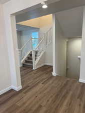 Stairs featuring hardwood / wood-style flooring